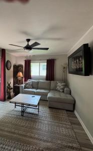 a living room with a couch and a coffee table at Super Comfy 3 BR Home Sleeps 8 in Doraville