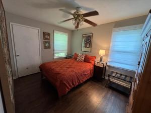 a bedroom with a bed and a ceiling fan at Super Comfy 3 BR Home Sleeps 8 in Doraville