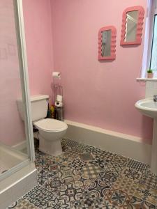 a pink bathroom with a toilet and a sink at Blackpool Rocks Pleasure Beach in Blackpool +39 photos