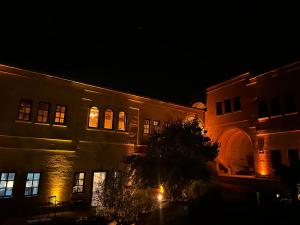 a building at night with its lights on at Hush Cappadocia Hotel in Ürgüp