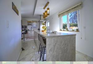 a kitchen with a large island in the middle at Villa 2 chambres in Trooz