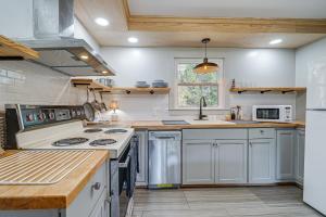a kitchen with white cabinets and a stove top oven at Deck & Spacious Yard! Wilmington Gem on Half-Acre in Wilmington