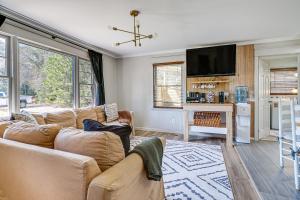 a living room with a couch and a tv at Deck & Spacious Yard! Wilmington Gem on Half-Acre in Wilmington