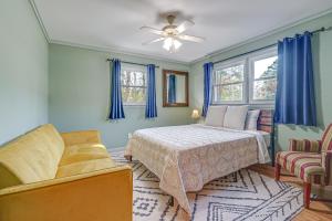 a bedroom with a bed and a couch at Deck & Spacious Yard! Wilmington Gem on Half-Acre in Wilmington