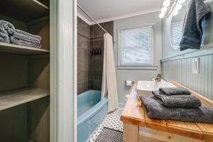 a bathroom with a tub and a sink and a shower at Deck & Spacious Yard! Wilmington Gem on Half-Acre in Wilmington +19 photos