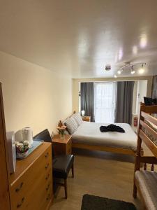 a small bedroom with a bed and a window at Travellers Rest Motel in Ingoldmells