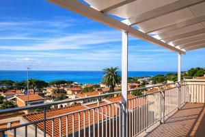 a balcony with a view of the ocean at Due Passi dal Cielo Apartment Piscina Condominiale fino al 30 Agosto in Anzio
