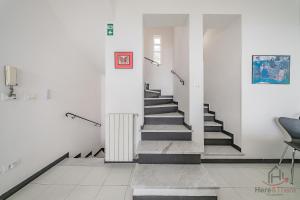 a hallway with stairs and a radiator in a building at Sea Dream - Vista Mare - Giardino - Box Privato in Bergeggi