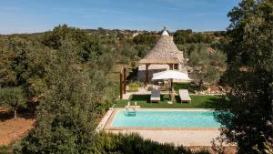 an overhead view of a swimming pool with a gazebo at Trullo Elisa in Monopoli