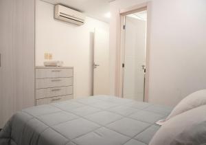 a white bedroom with a bed and a walk in shower at Zona shopping del Sol, Asunción in Asunción +19 photos