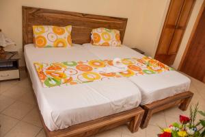 a bed with two pillows at Chez Jenny port Mathurin in Rodrigues Island