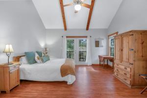 a bedroom with a bed and a dresser and a window at Fairlawn on the Blanco in Wimberley