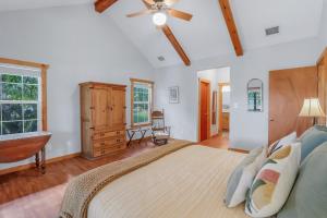 a bedroom with a large bed and a dresser at Fairlawn on the Blanco in Wimberley