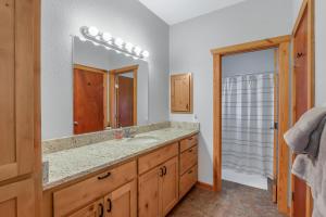 a bathroom with a sink and a large mirror at Fairlawn on the Blanco in Wimberley