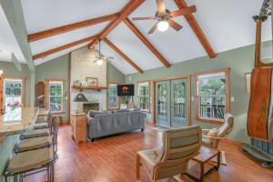 a living room with a ceiling fan and chairs at Fairlawn on the Blanco in Wimberley +38 photos