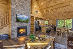 a living room with a fireplace in a log cabin at Ridge Hollow Retreat - Hot Tub, Fire Pit, Dogs in Gatlinburg