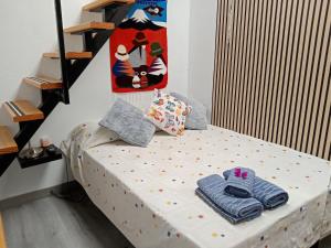 a small bed with towels on it in a room at Casa Klemann with private sun terrace in Cruce de Arinaga +38 photos