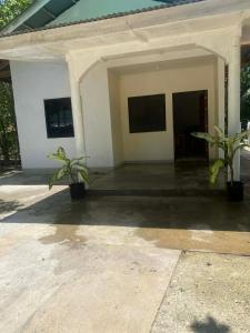 a house with two potted plants in front of it at Casa Fleur in Cangalwang +2 photos
