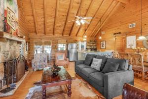 a living room with a couch and a table at Falls Log Home in Wimberley