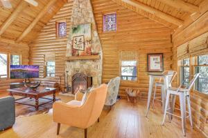 a living room with a fireplace in a log cabin at Falls Log Home in Wimberley +14 photos