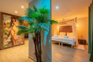 a bedroom with a bed and a painting of a woman at NÜ-DE GITES ET SPA in Zuydcoote