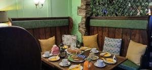 a table with food and a cake on it at Brunant Arms Hotel in Caio