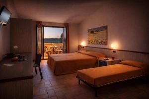 a hotel room with two beds and a balcony at Le Fiabe Hotel Resort in Numana +34 photos