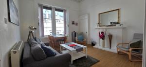 a living room with a couch and a table at Grindlay Street Residence, 2 Bedroom, 2 Bathroom apartment close to Castle in Edinburgh