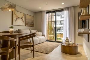 a living room with a couch and a table at WELL Residences - By AVA Rentals in Asunción