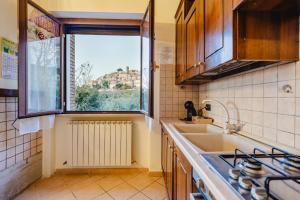 eine Küche mit Spüle und Fenster in der Unterkunft Casa Stefano in Casperia