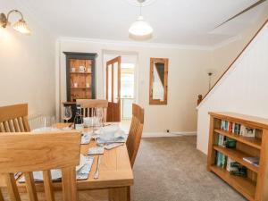 a dining room with a wooden table and chairs at Yewbarrow in Seascale