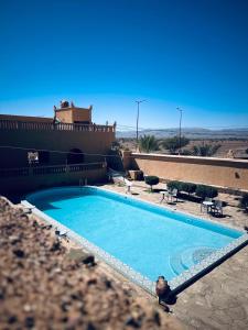 a large swimming pool in front of a building at Auberge camping ouadjou in Nkob