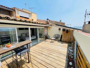 a deck with two chairs and a table on a house at Sunset lodge in Bouzigues