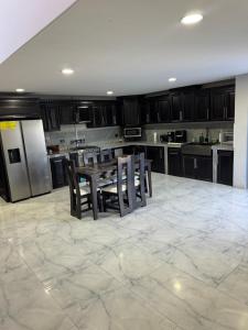 a kitchen with a table and chairs and a refrigerator at Brisa marina in Moín