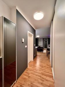 a hallway of an apartment with wood floors and a room at Studio Nuppu Comfort, AC in Trnávka