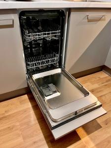 an open dishwasher with its door open in a kitchen at Studio Nuppu Comfort, AC in Trnávka +13 photos