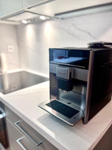 a laptop sitting on a counter in a kitchen at Studio Nuppu Comfort, AC in Trnávka