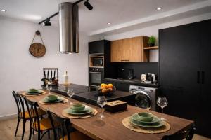 a kitchen with a wooden table with chairs and a dining room at Captivating 2-Bed Apartment in Tunis in Tunis