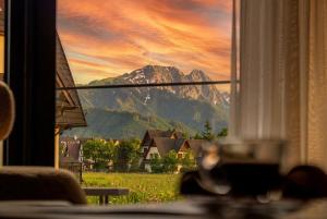 a view of a mountain from a window at CHATAR Tatra Premium Suites in Zakopane