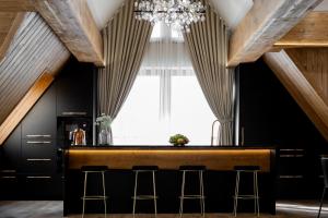 a bar in the middle of a room with a chandelier at CHATAR Tatra Premium Suites in Zakopane
