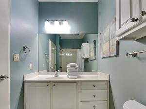 a bathroom with a white sink and a mirror at Inn at Seacrest #206 in Rosemary Beach +9 photos