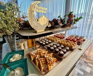 a buffet of desserts and pastries on a table at ART REGENCY Premium Hotel in Tashkent