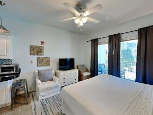 a bedroom with a bed and a ceiling fan at Inn at Seacrest #206 in Rosemary Beach