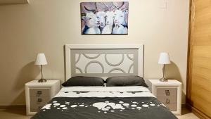 a bedroom with a bed with two night stands and two lamps at 2-bedroom apartment with terrace VistaRoja in Granadilla de Abona +20 photos