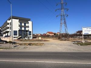 an empty street next to a building with a tower at Vert Unique Luxury Experience in Băile Felix in Baile Felix