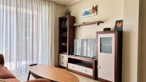a living room with a tv and a table at 2-bedroom apartment with terrace VistaRoja in Granadilla de Abona