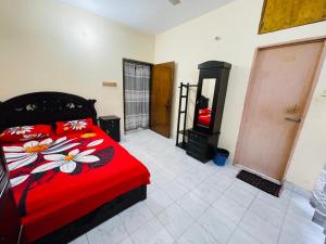 a bedroom with a red bed and a fireplace at Sylhet three bedroom apartment in Sylhet +15 photos