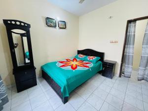 a bedroom with a bed with a flower on it at Sylhet three bedroom apartment in Sylhet