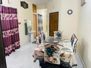 a dining room with a table and two chairs at Sylhet three bedroom apartment in Sylhet