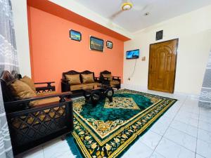 a living room with a couch and a rug at Sylhet three bedroom apartment in Sylhet